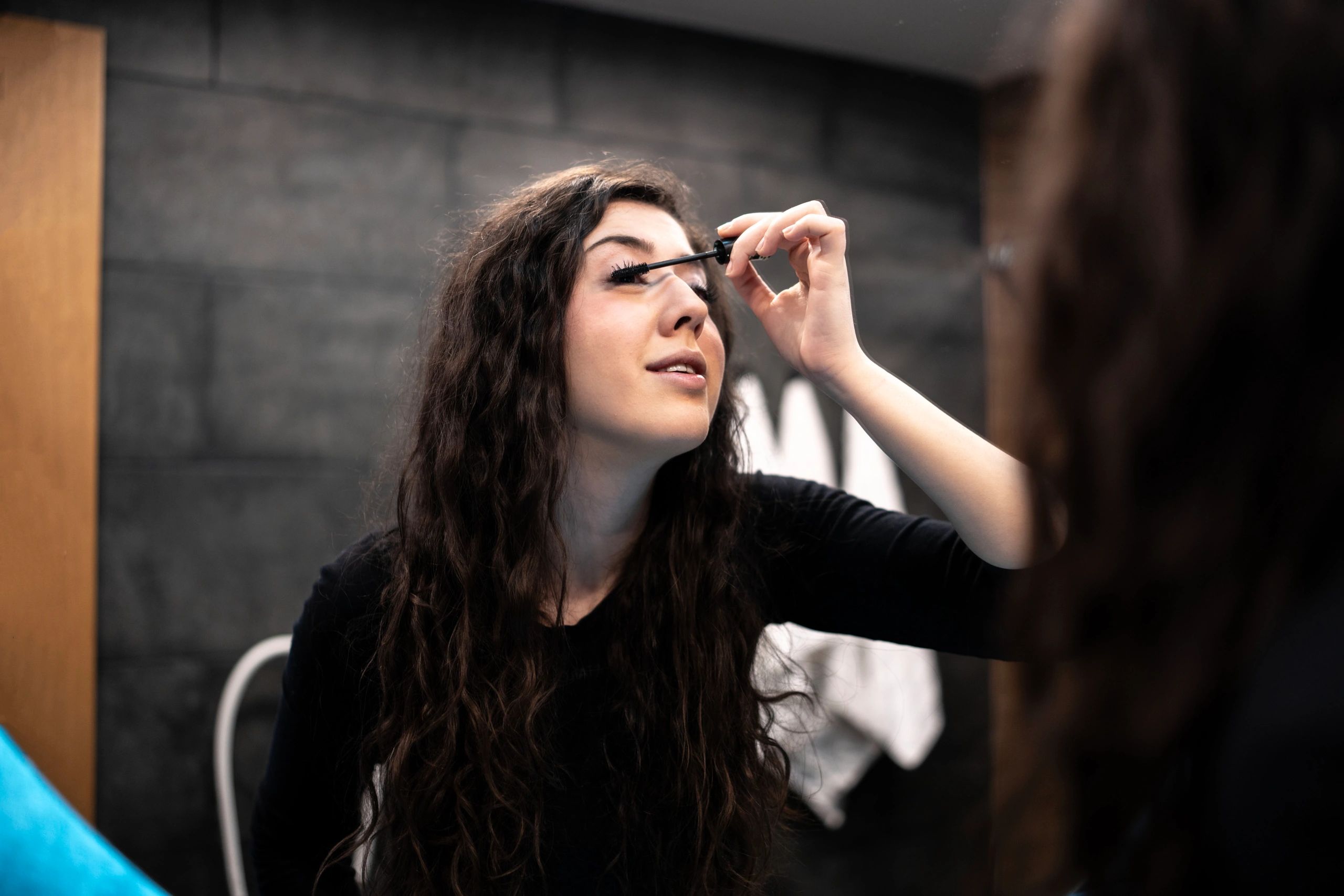 Woman getting ready with eye makeup and lashes